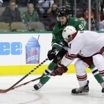 Dallas Stars center Tyler Seguin (91) and Arizona Coyotes defenseman Zbynek Michalek (4), of the Czech Republic, compete for control of a loose puck in the first period of an NHL hockey game, Thursday, Nov. 20, 2014, in Dallas. (AP Photo/Tony Gutierrez)