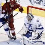 Tampa Bay Lightning's Ben Bishop (30) makes a save on a shot by Arizona Coyotes' David Moss (18) during the third period of an NHL hockey game Saturday, Feb. 21, 2015, in Glendale, Ariz. The Lightning defeated the Coyotes 4-2.(AP Photo/Ross D. Franklin)