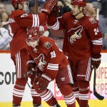 Arizona Coyotes' Kyle Chipchura (24) and Oliver Ekman-Larsson, left, of Sweden, celebrate a goal by Mikkel Boedker (89), of Denmark, against the San Jose Sharks during the first period of an NHL hockey game Tuesday, Jan. 13, 2015, in Glendale, Ariz. (AP Photo/Ross D. Franklin)
