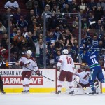 Vancouver Canucks' Alex Burrows (14) celebrates his goal against Arizona Coyotes goalie Mike Smith as Antoine Vermette (50), Shane Doan (19) and Michael Stone (26) react during first period of an NHL hockey game in Vancouver, British Columbia, Monday, Dec. 22, 2014. (AP Photo/The Canadian Press, Darryl Dyck)