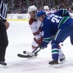 Vancouver Canucks' Henrik Sedin, of Sweden, (33) wins a face-off against Arizona Coyotes' Sam Gagner during first period of an NHL hockey game in Vancouver, British Columbia, Monday, Dec. 22, 2014. (AP Photo/The Canadian Press, Darryl Dyck)