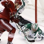 Dallas Stars' Kari Lehtonen, right, of Finland, makes a diving save on a shot by Arizona Coyotes' Mikkel Boedker, of Denmark, during the third period of an NHL hockey game Tuesday, Nov. 11, 2014, in Glendale, Ariz. The Stars defeated the Coyotes 4-3. (AP Photo/Ross D. Franklin)