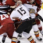 Anaheim Ducks' Ryan Getzlaf (15) and Arizona Coyotes' Shane Doan (19) start to fight during the second period of an NHL hockey game Tuesday, March 3, 2015, in Glendale, Ariz. (AP Photo/Ross D. Franklin)