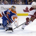 Arizona Coyotes' Sam Gagner (9) is stopped by Edmonton Oilers goalie Viktor Fasth, left, during the first period of an NHL hockey game in Edmonton, Alberta., Monday, Dec. 1, 2014. (AP Photo/The Canadian Press, Jason Franson)