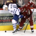 Toronto Maple Leafs center Jay McClement (11) shields Phoenix Coyotes right wing Radim Vrbata (17) from the puck after losing his stick in the third period during an NHL hockey game, Monday, Jan. 20, 2014, in Glendale, Ariz. (AP Photo/Rick Scuteri)