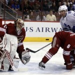 Phoenix Coyotes goalie Mike Smith (41) makes the save in front of Toronto Maple Leafs right wing Joffrey Lupul (19) in the first period of an NHL hockey game, Monday, Jan. 20, 2014, in Glendale, Ariz. (AP Photo/Rick Scuteri)