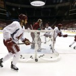 Phoenix Coyotes' Paul Bissonnette, left, skates past goalie Mike Smith, second from left, as they watch teammates battle for the puck during an NHL hockey practice, Tuesday, Jan. 15, 2013, in Glendale, Ariz. (AP Photo/Ross D. Franklin)