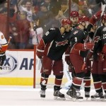 Phoenix Coyotes' Radim Vrbata, of the Czech Republic, celebrates his goal scored against the Calgary Flames with teammates Mike Ribeiro (63), Martin Hanzal (11), of the Czech Republic, Keith Yandle (3) and Oliver Ekman-Larsson (23), of Sweden, as Flames' Dennis Wideman (6) skates away during the first period of an NHL hockey game on Tuesday Oct. 22, 2013, in Glendale, Ariz. (AP Photo/Ross D. Franklin)
