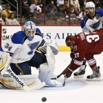 St. Louis Blues' Jake Allen (34) makes a save on a shot by Phoenix Coyotes' Raffi Torres (37) as Blues' Alex Pietrangelo (27) watches in the first period of an NHL hockey game, Thursday March 7, 2012, in Glendale, Ariz. (AP Photo/Ross D. Franklin)