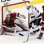 Phoenix Coyotes goalie Mike Smith (41) stops a shot on goal by Los Angeles Kings left wing Dustin Penner (25) as Coyotes' Keith Yandle (3) defends during the first period of Game 2 of the NHL hockey Stanley Cup Western Conference finals, Tuesday, May 15, 2012, in Glendale, Ariz. (AP Photo/Ross D. Franklin)