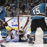 Phoenix Coyotes goalie Mike Smith, center, blocks a shot attempt from San Jose Sharks center Michal Handzus (26), of the Czech Republic, as center James Sheppard (15) watches during the first period of an NHL hockey game in San Jose, Calif., Saturday, Feb. 9, 2013. (AP Photo/Marcio Jose Sanchez)
