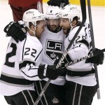 Los Angeles Kings' Trevor Lewis (22), Drew Doughty (8), and Jarret Stoll (28) celebrate a goal by Dwight King against the Phoenix Coyotes in the first period during Game 2 of the NHL hockey Stanley Cup Western Conference finals, Tuesday, May 15, 2012, in Glendale, Ariz. (AP Photo/Ross D. Franklin)