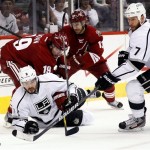 Los Angeles Kings defenseman Drew Doughty (8) battles Phoenix Coyotes right wing Shane Doan (29) and Ray Whitney (13) for the puck as Kings' Rob Scuderi (7) pursues during the first period of Game 2 of the NHL hockey Stanley Cup Western Conference finals, Tuesday, May 15, 2012, in Glendale, Ariz. (AP Photo/Matt York)