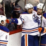 Edmonton Oilers' Nail Yakupov (64), of Russia, celebrates his game-winning goal against the Phoenix Coyotes with teammates Taylor Hall (4) and Ryan Whitney (6)during overtime in an NHL hockey game Wednesday, Jan. 30, 2013, in Glendale, Ariz. The Oilers defeated the Coyotes 2-1 in overtime.(AP Photo/Ross D. Franklin)
