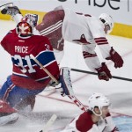 Phoenix Coyotes' Tim Kennedy flips next to Montreal Canadiens goalie Carey Price during the third period of an NHL hockey game Tuesday, Dec. 17, 2013, in Montreal. (AP Photo/The Canadian Press, Paul Chiasson)