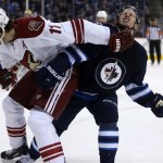 Phoenix Coyotes' Martin Hanzal (11) gives Winnipeg Jets' Bryan Little (18) a forearm to the face during second period NHL hockey action in Winnipeg, Canada, Monday, Jan. 13, 2014. (AP Photo/The Canadian Press, Trevor Hagan)
