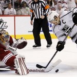 Phoenix Coyotes goalie Mike Smith, left, makes a save on a shot by Los Angeles Kings' Dustin Brown as Coyotes' Oliver Ekman-Larsson, of Sweden, far right, defends in the second period during Game 2 of the NHL hockey Stanley Cup Western Conference finals, Tuesday, May 15, 2012, in Glendale, Ariz. (AP Photo/Ross D. Franklin)