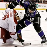 Los Angeles Kings' Mike Richards (10) battles Phoenix Coyotes' Boyd Gordon (15) for the puck after a face-off in the first period during an NHL hockey game Tuesday, March 12, 2013, in Glendale, Ariz. (AP Photo/Ross D. Franklin)
