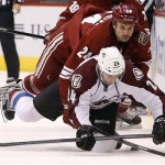  Colorado Avalanche's Marc-Andre Cliche, bottom, gets taken down by Phoenix Coyotes' Kyle Chipchura during the second period of an NHL hockey game Thursday, Nov. 21, 2013, in Glendale, Ariz. (AP Photo/Ross D. Franklin)