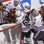 Phoenix Coyotes' Kyle Chipchura (24) and Chicago Blackhawks' Andrew Shaw (62) are sepereted by teammates and an official during a fight in the second period of an NHL hockey game, Sunday, Jan. 20, 2013, in Glendale, Ariz. (AP Photo/Matt York)
