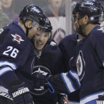  Winnipeg Jets' Blake Wheeler (26), Bryan Little (18) Dustin Byfuglien (33) and Andrew Ladd (16) celebrate Little's goal against the Phoenix Coyotes during second-period NHL hockey game action in Winnipeg, Manitoba, Thursday, Feb. 27, 2014. (AP Phoyo/The Canadian Press, John Woods)
