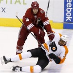 Phoenix Coyotes' Rostislav Klesla (16), of the Czech Republic, checks Philadelphia Flyers' Wayne Simmonds (17) to the ice during the first period of an NHL hockey game Saturday, Jan. 4, 2014, in Glendale, Ariz. (AP Photo/Ross D. Franklin)