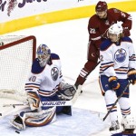 Edmonton Oilers' Devan Dubnyk (40) makes a save on a shot as Coyotes' Nick Johnson (32) and Oilers' Jeff Petry (2) watches during the second period in an NHL hockey game Wednesday, Jan. 30, 2013, in Glendale, Ariz.(AP Photo/Ross D. Franklin)