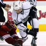 Los Angeles Kings center Jarret Stoll (28) works to keep the puck from Phoenix Coyotes center Boyd Gordon (15) during the first period during an NHL hockey game Saturday, Jan. 26, 2013, in Glendale, Ariz. (AP Photo/Rick Scuteri)
