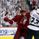 Phoenix Coyotes left wing Taylor Pyatt, left, celebrates his goal as Los Angeles Kings defenseman Willie Mitchell (33) looks away during the first period of Game 5 of the NHL hockey Stanley Cup Western Conference finals, Tuesday, May 22, 2012, in Glendale, Ariz. (AP Photo/Matt York)