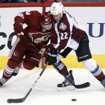 Phoenix Coyotes right winger Chris Conner, left, battles Colorado Avalanche defenseman Matt Hunwick, right, for the puck in the second period of NHL hockey game, Saturday, April 6, 2013, in Glendale, Ariz. (AP Photo/Paul Connors)
