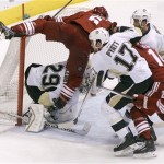  Phoenix Coyotes' Connor Murphy (5) collides with Pittsburgh Penguins goaltender Marc-Andre Fleury (29) as Penguins' Taylor Pyatt (17) and Brooks Orpik, second from right, chase down the puck ahead of Coyotes' Jeff Halpern (14) and Kyle Chipchura (24) during the second period of an NHL hockey game on Saturday, Feb. 1, 2014, in Glendale, Ariz. (AP Photo/Ralph Freso)