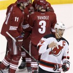  New Jersey Devils' Bryce Salvador (24) skates away from the celebration of Phoenix Coyotes' Martin Hanzal (11), of the Czech Republic, with teammates Keith Yandle (3), Oliver Ekman-Larsson (23), of Sweden, and Mike Ribeiro (63) after Hanzal scored a goal during the second period of an NHL hockey game, Saturday, Jan. 18, 2014, in Glendale, Ariz. (AP Photo/Ross D. Franklin)