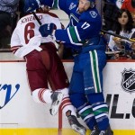 Vancouver Canucks' Ryan Kesler, right, checks Phoenix Coyotes' David Schlemko during the first period of an NHL hockey game in Vancouver, British Columbia, on Monday April 8, 2013. (AP Photo/The Canadian Press, Darryl Dyck)