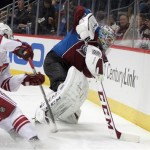 Colorado Avalanche goalie Semyon Varlamov, right, of Russia, reaches for the puck behind his net as Phoenix Coyotes right wing Jordan Szwarz skates into the play during the first period of an NHL hockey game in Denver on Tuesday, Dec. 10, 2013. (AP Photo/Joe Mahoney)