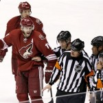 Phoenix Coyotes' Martin Hanzal (11), of the Czech Republic, and David Moss (18) argues with referees Ghislain Herbert (22) and Dave Jackson, third from left, and linesmen Ryan Galloway and Jay Sharrers (57) after a Coyotes goal was disallowed during the third period of an NHL hockey game against the Colorado Avalanche Thursday, Nov. 21, 2013, in Glendale, Ariz. The Avalanche defeated the Coyotes 4-3. (AP Photo/Ross D. Franklin)