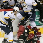 Nashville Predators right wing Matt Halischuk (24) and Phoenix Coyotes left wing David Moss (18) battle for the puck in the second period during an NHL hockey game on Monday, Jan. 28, 2013, in Glendale, Ariz. (AP Photo/Rick Scuteri)