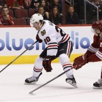 Chicago Blackhawks' Brandon Saad (20) tries to keep Phoenix Coyotes' Oliver Ekman-Larsson (23), of Sweden, away as Saad tries to get off a shot during the first period in an NHL hockey game, Friday Feb. 7, 2014, in Glendale, Ariz. (AP Photo/Ross D. Franklin)