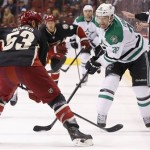  Dallas Stars' Vernon Fiddler (38) loses control of the puck in front of Phoenix Coyotes' Derek Morris (53) during the first period of an NHL hockey game, Tuesday, Feb. 4, 2014, in Glendale, Ariz. (AP Photo/Ross D. Franklin)