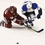 Phoenix Coyotes' Steve Sullivan (26) and St. Louis Blues' T.J. Oshie (74) battle as they try to get to the puck in the third period of an NHL hockey gamen Thursdayn March 7, 2013, in Glendale, Ariz. The Blues won 6-3. (AP Photo/Ross D. Franklin)