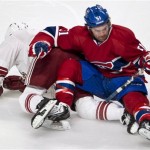 Montreal Canadiens' David Desharnais falls over Phoenix Coyotes' Keith Yandle during the first period of an NHL hockey game Tuesday, Dec. 17, 2013, in Montreal. (AP Photo/The Canadian Press, Paul Chiasson)