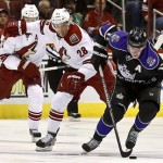 Los Angeles Kings' Anze Kopitar (11), of Slovenia, gets the puck in front of Phoenix Coyotes' Lauri Korpikoski (28), of Finland, during the first period of an NHL hockey game Tuesday, March 12, 2013, in Glendale, Ariz. (AP Photo/Ross D. Franklin)