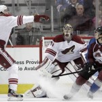 Phoenix Coyotes center Martin Hanzal (11) reaches for the puck as Phoenix Coyotes goalie Mike Smith (41) and Colorado Avalanche right wing P.A. Parenteau (15) watch during the first period of an NHL hockey game, Monday, Feb. 11, 2013, in Denver. (AP Photo/Joe Mahoney)