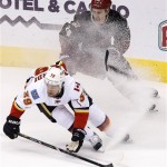 Calgary Flames' T.J. Galiardi (39) gives Phoenix Coyotes' Michael Stone (26) a spray of ice during the second period of an NHL hockey game Tuesday, Jan. 7, 2014, in Glendale, Ariz. Phoenix defeated Calgary 6-0. (AP Photo/Ross D. Franklin)