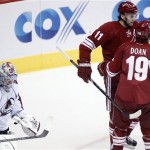 Phoenix Coyotes center Martin Hanzal, center ,of the Czech Republic, congratulates teammate Shane Doan, right, after Doan scored a goal against Colorado Avalanche goalie Semyon Varlamov, left, of Russia, in the second period of NHL hockey game Saturday, April 6, 2013, in Glendale, Ariz. (AP Photo/Paul Connors)
