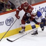 Phoenix Coyotes' Rob Klinkhammer (36) chases down a loose puck in front of St Louis Blues' Kevin Shattenkirk during the second period of an NHL hockey game Sunday, March 2, 2014, in Glendale, Ariz. (AP Photo/Ralph Freso)