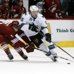 Phoenix Coyotes defenseman Connor Murphy (5), left, steals the puck from San Jose Sharks left wing James Sheppard (15) in the first period during an NHL hockey game on Friday, Dec. 27, 2013, in Glendale, Ariz. (AP Photo/Rick Scuteri)