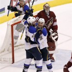 St Louis Blues' David Backes (42) and T.J. Oshie (74) celebrate in front of Phoenix Coyotes goaltender Mike Smith (41) after a goal by Blues' teammate Kevin Shattenkirk, not pictured, during the third period of an NHL hockey game, Sunday, March 2, 2014, in Glendale, Ariz. The Blues defeated the Coyotes 4-2. (AP Photo/Ralph Freso)