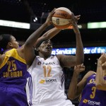 Phoenix Mercury's Lynetta Kizer (12) goes up for a shot against Los Angeles Sparks' Marissa Coleman (25) and Candace Parker (3) during the first half in a WNBA basketball game on Friday, June 14, 2013, in Phoenix. (AP Photo/Ross D. Franklin)