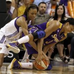 Phoenix Mercury's DeWanna Bonner, left, battles Los Angeles Sparks' Candace Parker for the loose ball during the first half in a WNBA basketball game on Friday, June 14, 2013, in Phoenix. (AP Photo/Ross D. Franklin)