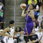 Phoenix Mercury's Candice Dupree, right, leaps in an attempt to keep the ball inbounds as Seattle Storm's Tanisha Wright looks on in the first half of a WNBA basketball game, Sunday, June 2, 2013, in Seattle. (AP Photo/Elaine Thompson)